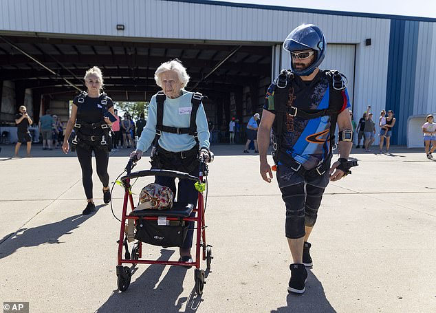 She left her walker just short of the plane - a white Skyvan - and was helped up the stairs by two guides to join the others waiting inside.