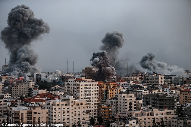 Smoke rises over the buildings as Israeli airstrikes continue in the Al-Rimal neighborhood of Gaza City