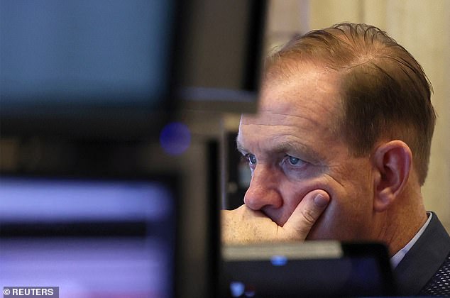 A trader is seen at work on the floor of the New York Stock Exchange.  The war causes great uncertainty in the markets