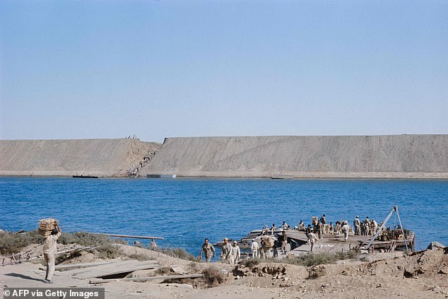 The Suez Canal is pictured in 1973, as Egyptian soldiers transport supplies.  The canal is of crucial strategic importance and now carries seven percent of all world trade