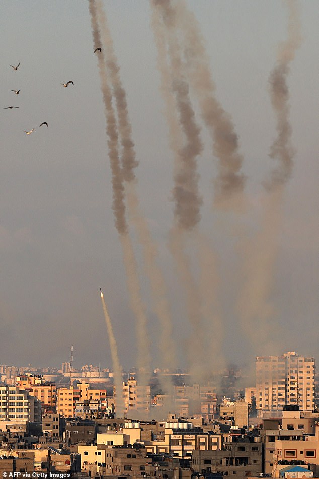 Devastating: About 1,900 people have been reported killed in the conflict since Saturday, including 1,000 dead in Israel and 900 in Gaza;  Dramatic photos show rockets fired from Gaza towards Israel on Tuesday