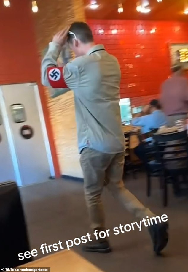 The group appeared to have just finished their food and casually strolled into the restaurant in Nazi paraphernalia