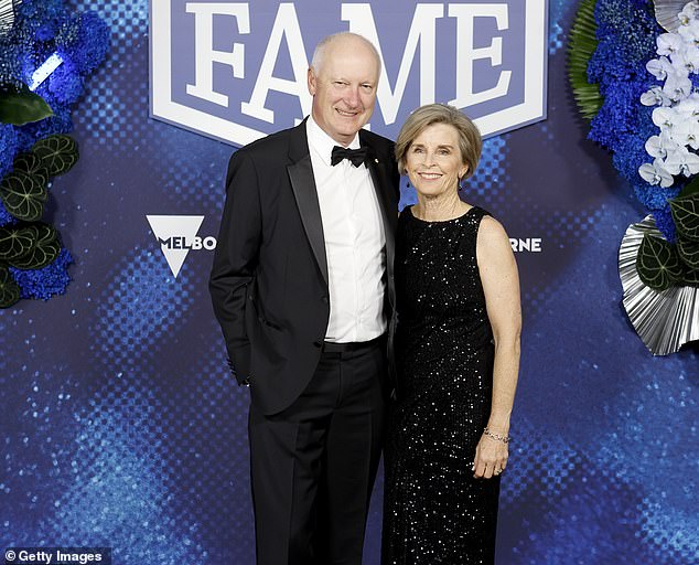 Qantas chairman Richard Goyder (pictured with wife Janine) has announced he will step down next year as he apologizes for 'mistakes' made by the national carrier.