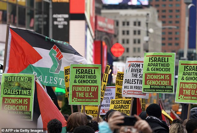 Pro-Palestinian protesters continued to chant 'resistance is justified' into the afternoon - as a sea of ​​signs and placards took over Times Square