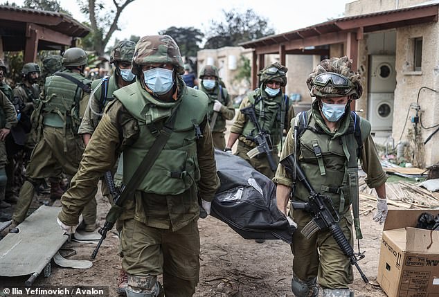 Israeli forces retrieve bodies of Israeli residents from a destroyed house as fighting continues between Israeli troops and Islamist Hamas militants