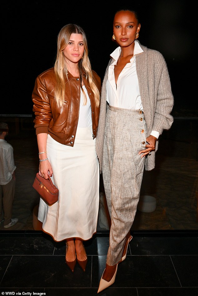 The pairing: Jasmin emphasized her toned waist by tucking her white blouse into high-waisted trousers, which were complemented by her pale gray cardigan