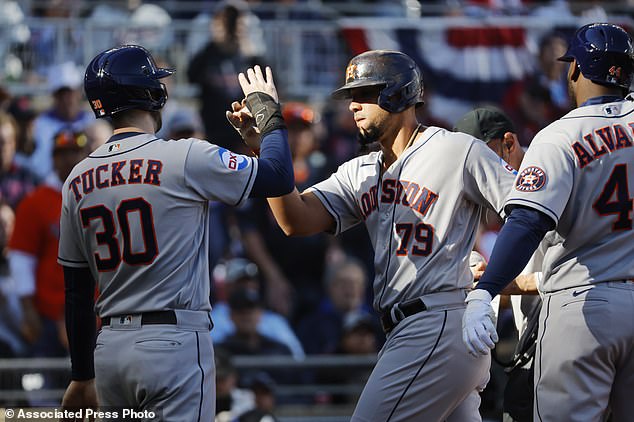 Abreu is greeted at the plate by Kyle Tucker after a three-run homer in the first inning