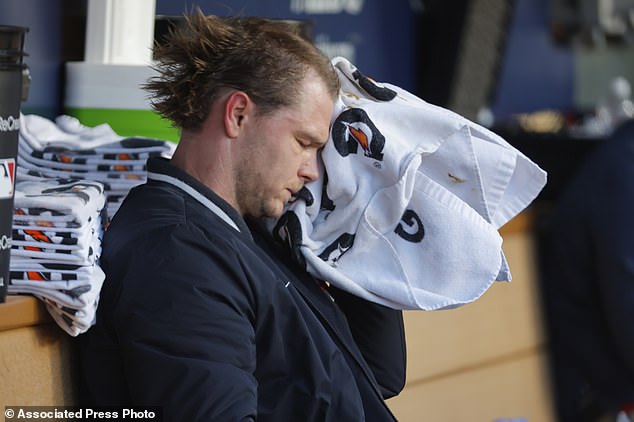 Twins starting pitcher Sonny Gray wipes his face after being relieved in the fifth inning