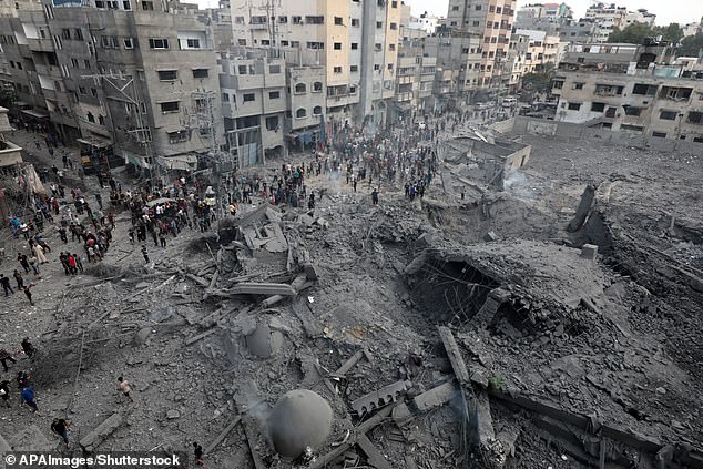 Palestinians inspect the damage after an Israeli airstrike on Gaza City as the Israeli response to the aggressors intensifies