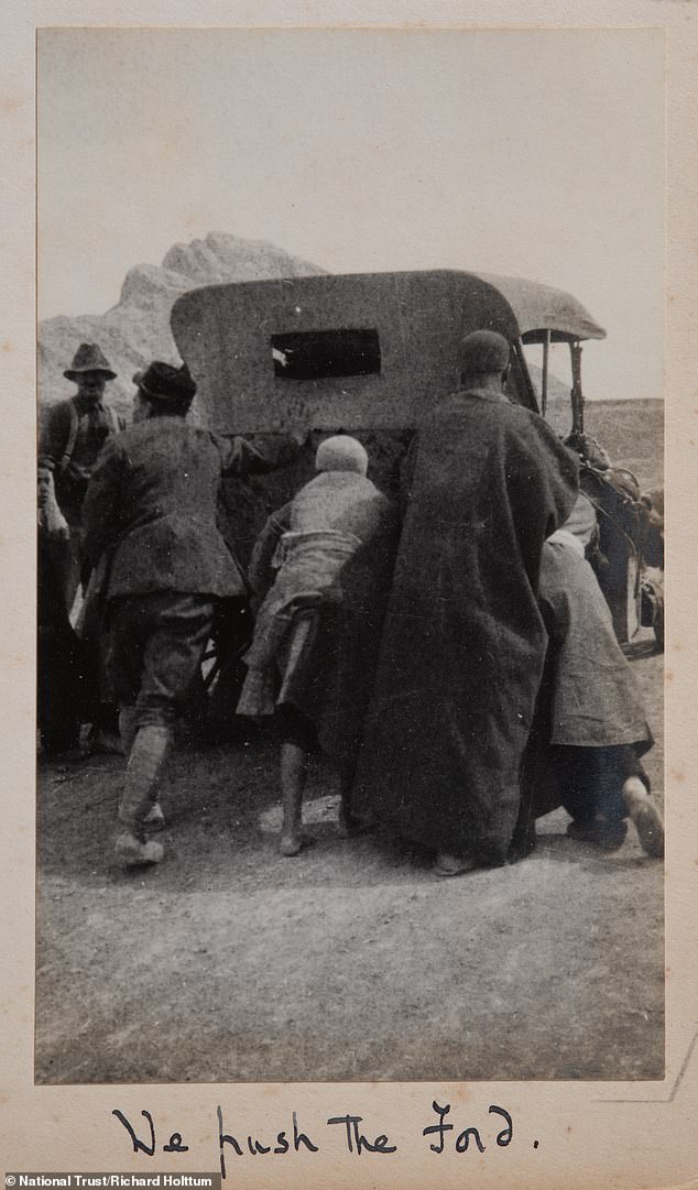 The couple is seen getting help while pushing their car after it apparently broke down