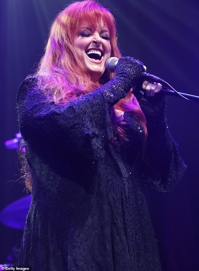 Delivery: With her signature flaming red hair down, Wynonna was dressed in black as she stepped out into the crowd to perform at the Barn