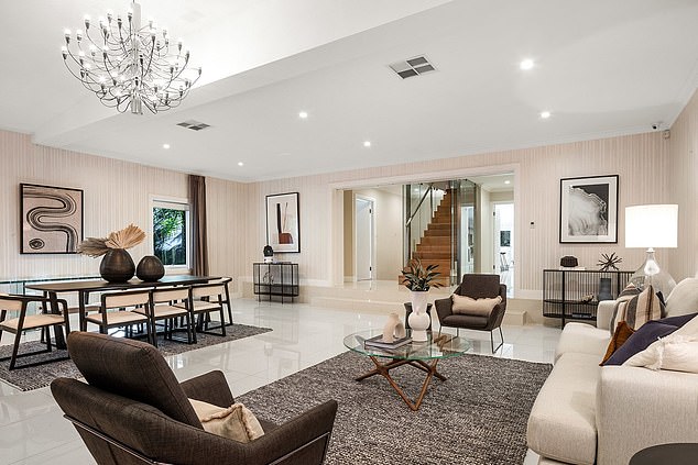 Initially setting out to redo just their kitchen, the pair redesigned the interiors of the entire home.  Pictured: The living area inside Marshall's before their makeover