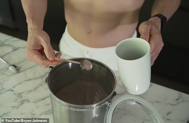 He prepares his food for the morning (pictured here making his green monster drink) before starting his intense workout for the day