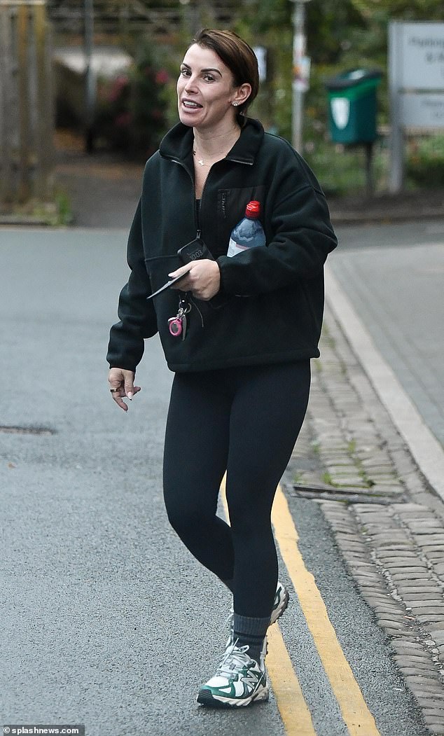 Sporting: Coleen cut a very casual figure as she wore a pair of black sports leggings and green and white New Balance trainers as she headed out for training