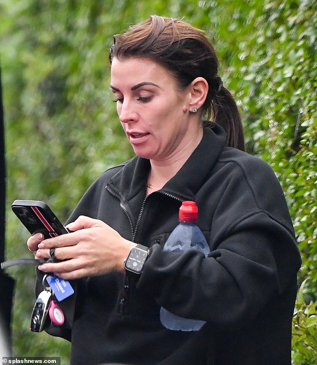 Keeping warm: She opted for a black quarter-zip fleece as she tied her brunette locks into a low ponytail