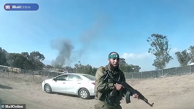 A Hamas member holding a gun at the electronic music festival near Kibbutz Re'im