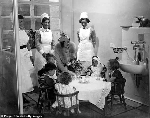 Queen Elizabeth talks to patients at Great Ormond Street during her visit