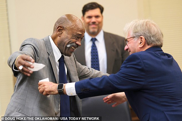 It wasn't until Tuesday that a judge in Ada, Oklahoma, acquitted Lott and permanently dismissed the case.  (Pictured: Perry Lott, left, goes to hug Innocence Project founder Barry Scheck, who advocated for him, after the judge vacated his conviction)