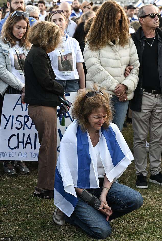 A woman breaks down in tears during the vigil