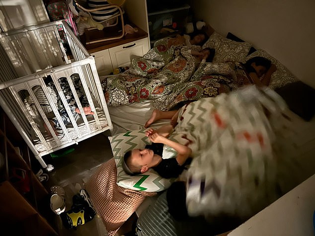 The second showed a similar scene: another small room, albeit with slightly more belongings, this time with at least five children lying on mattresses and in a cot.