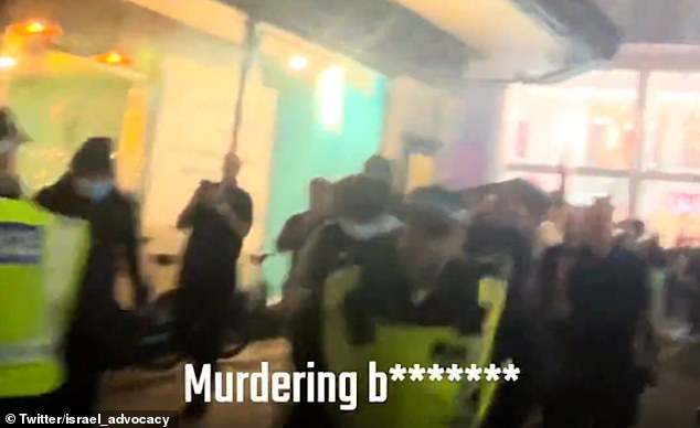 Chaos appears to break out afterwards, with officers seemingly pulling the two groups apart as they shout at each other.  'Murder b********!  Hamas supports c****!'  one shouted, while another shouted: 'Free, free Palestine!'