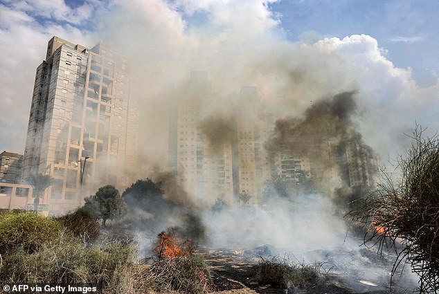 Smoke pours from a burning building after the rocket attacks that targeted several cities across Israel.  In the photo: Ashkelon Wednesday