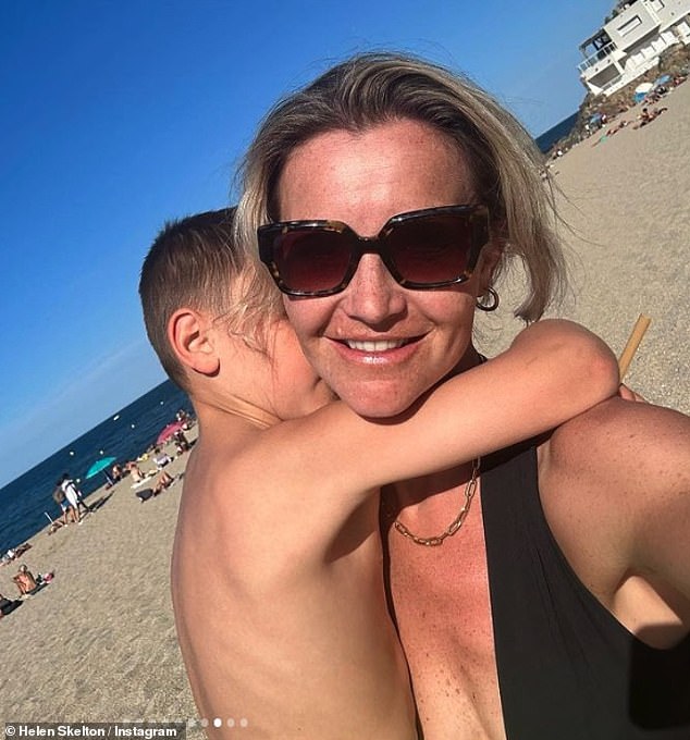 Mum: Helen looked sensational in a skimpy black two-piece as she hit the beach with children Ernie, eight, Louis, six, and Elsie, two