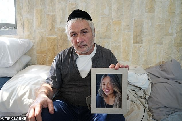 Ravit's father, Shimon Asayag, holding his picture