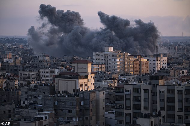 Israel has continued to crack down on the Gaza Strip, with the enclave's residents facing ever-increasing insecurity following the shutdown of the territory's only power plant.  Pictured: Smoke rises from buildings in Gaza after an Israeli airstrike on Wednesday