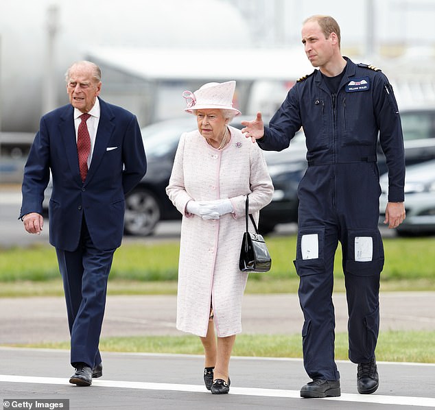 Prince William shows his grandparents around the East Anglian Air Ambulances base in Cambridge in July 2016