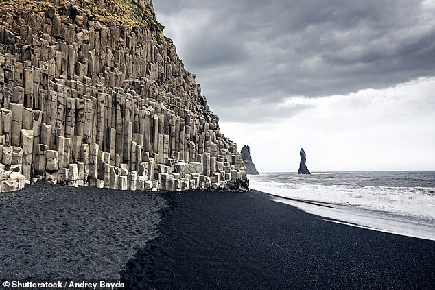 Sean explores Reynisfjara Beach (above), a world of towering dark sea stacks, elegant expanses of coal-black sand and hexagonal terraces of basalt cliffs