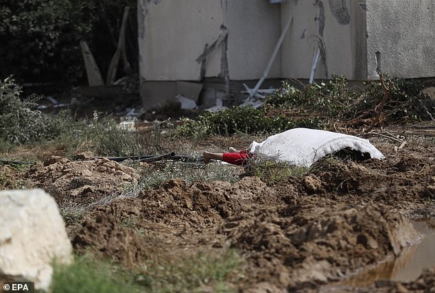 The body of a woman is covered with a blanket in Kfar Azza