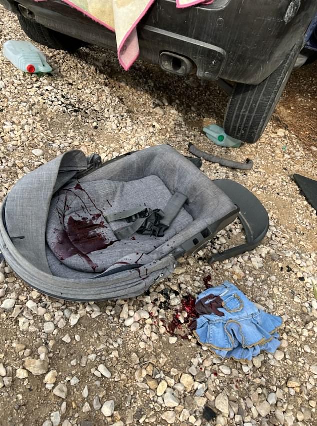 A baby seat and a child's dress are spattered in blood in the aftermath of the attack