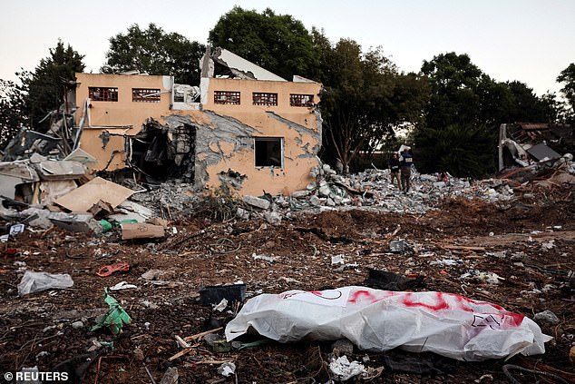 A dead body lies on the ground after a mass infiltration by Hamas gunmen from the Gaza Strip, in Kibbutz Beeri in southern Israel, October 11, 2023