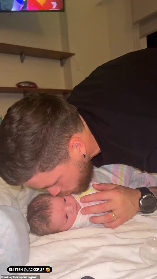 The doting parents also shared precious footage of AFL star Jack kissing Murphy, before placing a tiny ponytail on his head and picking him up.  In photo