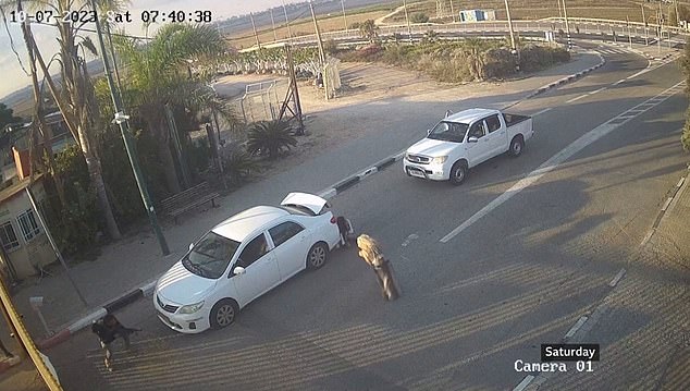 Behind the gate, a second gunman could be seen firing at the soldiers