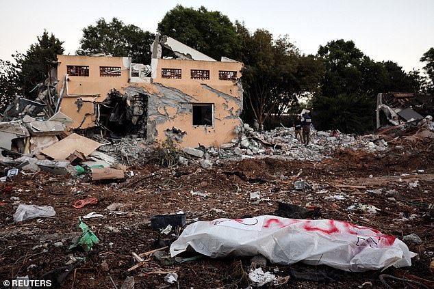 A body lies on the ground after a massive infiltration by Hamas militants from the Gaza Strip, in Kibbutz Beri, southern Israel, October 11, 2023.