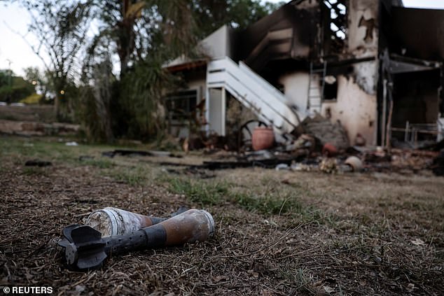 A mortar lies on the grass in Kibbutz Beeri after strikes on October 11, 2023.