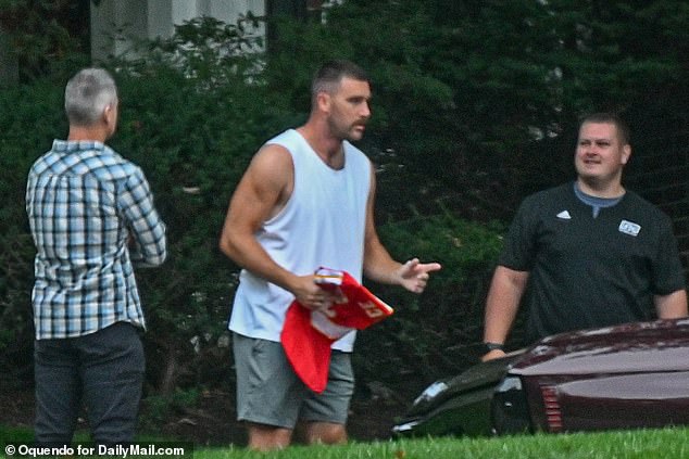 Travis Kelce was spotted outside his home holding one of his own jerseys ahead of tonight's Chiefs game, which girlfriend Taylor Swift is expected to attend