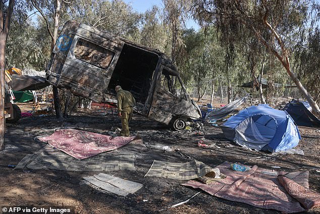 Israeli soldiers are seen at the site of the music festival on Thursday