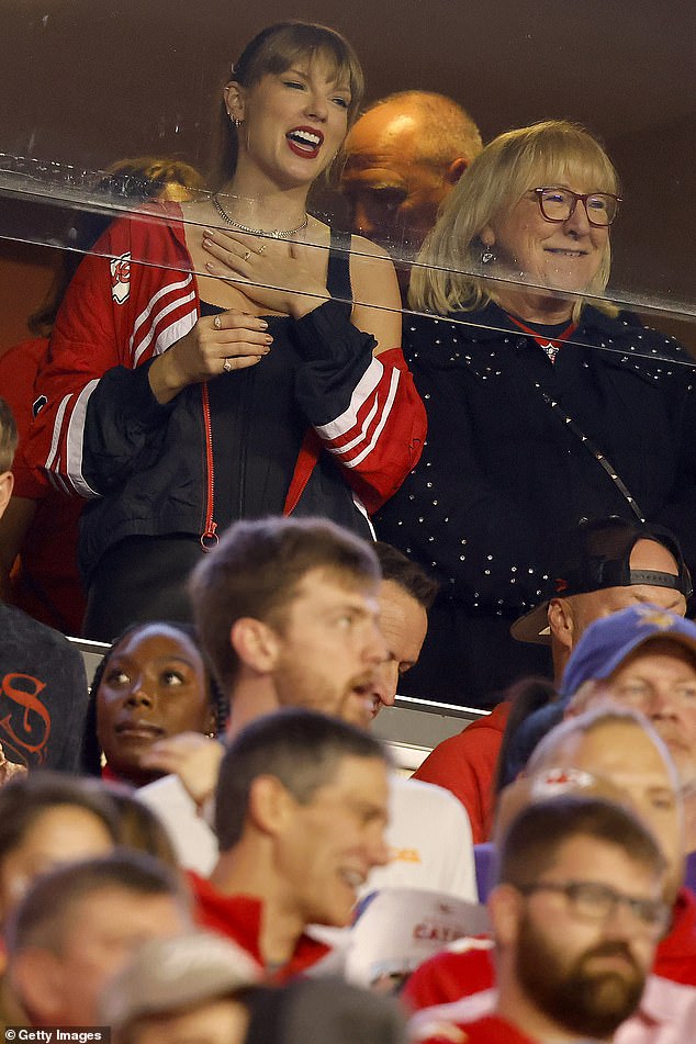 Details: In a VIP box next to Travis' mother Donna, Taylor wrapped herself in a Chiefs windbreaker branded by former Dancing With The Stars host Erin Andrews