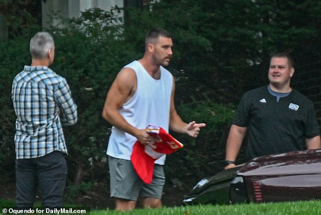 Travis Kelce was spotted outside his home holding one of his own jerseys ahead of tonight's Chiefs game, which girlfriend Taylor Swift is expected to attend