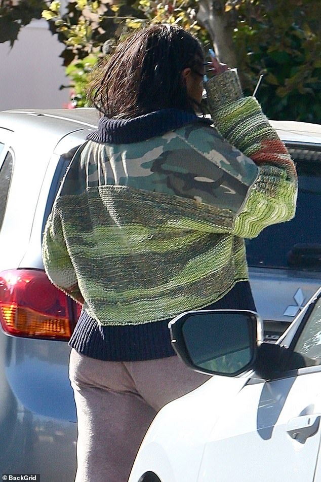 Sasha, who recently graduated from USC, wore a neutral-colored top that flared out in the middle and added a layer of warmth with a turtleneck sweater.