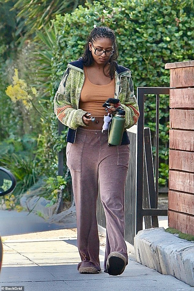 Malia Obama's younger sister, 25, opted for comfortable loose sweatpants for the visit to her friend's house and completed the look with a pair of slipper-like shoes.