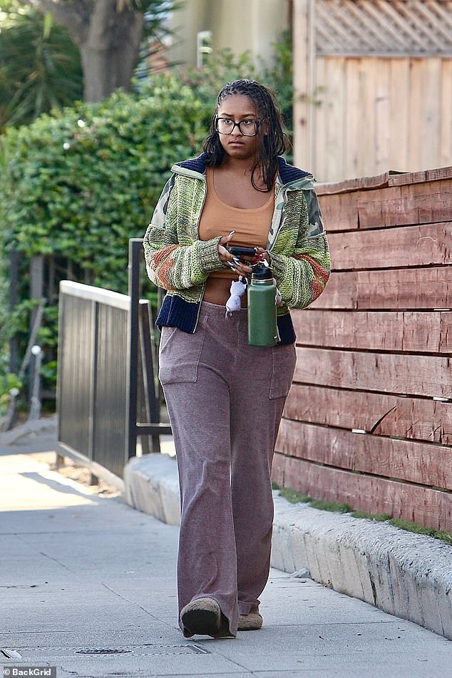 Sasha made another bold statement with her long metallic acrylic nails which poked out from the oversized sleeves of her sweater.