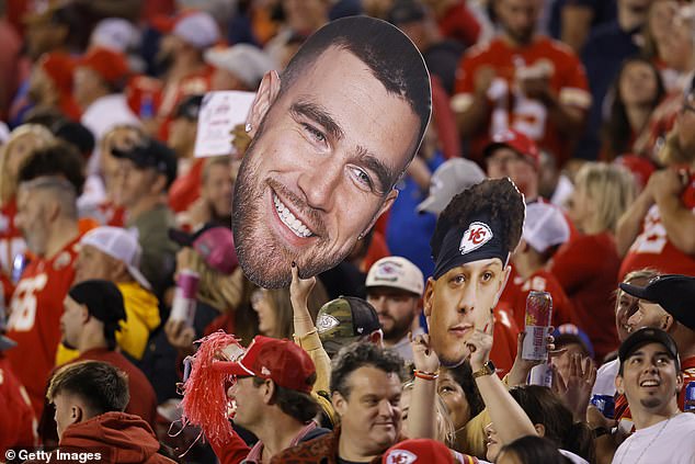 Fans hold photos of Kelce #87 and Patrick Mahomes at Arrowhead Field on Thursday