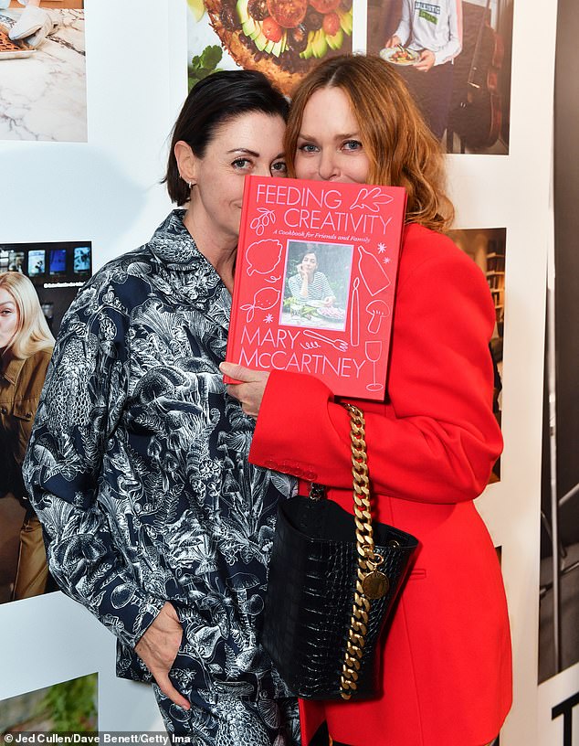 Say cheese: The sisters playfully posed with a book