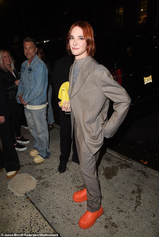 Pop of colour: Harry Neff, 30, looked sharp in a gray suit paired with orange shoes and a yellow bag