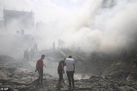 Palestinians search for survivors after an Israeli airstrike in the Rafah refugee camp in the southern Gaza Strip, Thursday, October 12, 2023. As Israel escalates its war against Hamas, it will face many of the same dilemmas that has faced during the decades of conflict with the Palestinians.  It will want to punish Hamas like never before, but without killing so many Palestinian civilians that it loses international support.  (AP Photo/Hatem Ali)