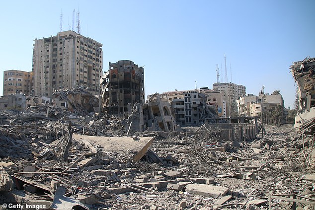 Palestinian citizens inspect the damage to their homes caused by Israeli airstrikes on October 13